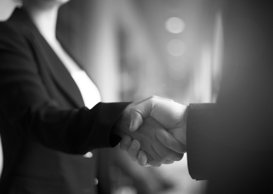 A business woman and man shaking hands